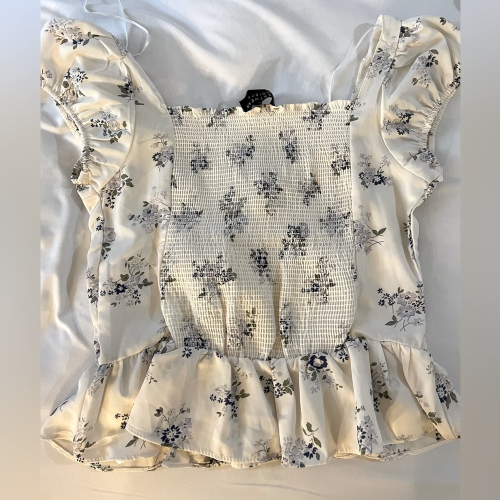 White and blue floral peplum top